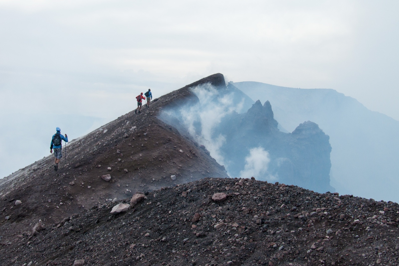 Hikers in warm layers high on Mount Etna